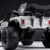 TASTIEN RC Truck - Rear Angle and Wing Rear three-quarter view of the TASTIEN RC truck showing the wing, rear suspension springs and skid plate
