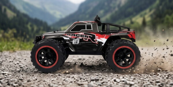 Yile Storm RC Truck - Gravel Action Red and grey Yile Storm RC truck spraying gravel as it accelerates on a mountain track