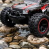 Yile Storm RC Truck - Off-Road Tyre Detail Close-up of the Yile Storm RC truck front tyre and bull bar as it climbs over wet river stones