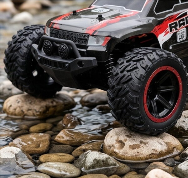 Yile Storm RC Truck - Off-Road Tyre Detail Close-up of the Yile Storm RC truck front tyre and bull bar as it climbs over wet river stones